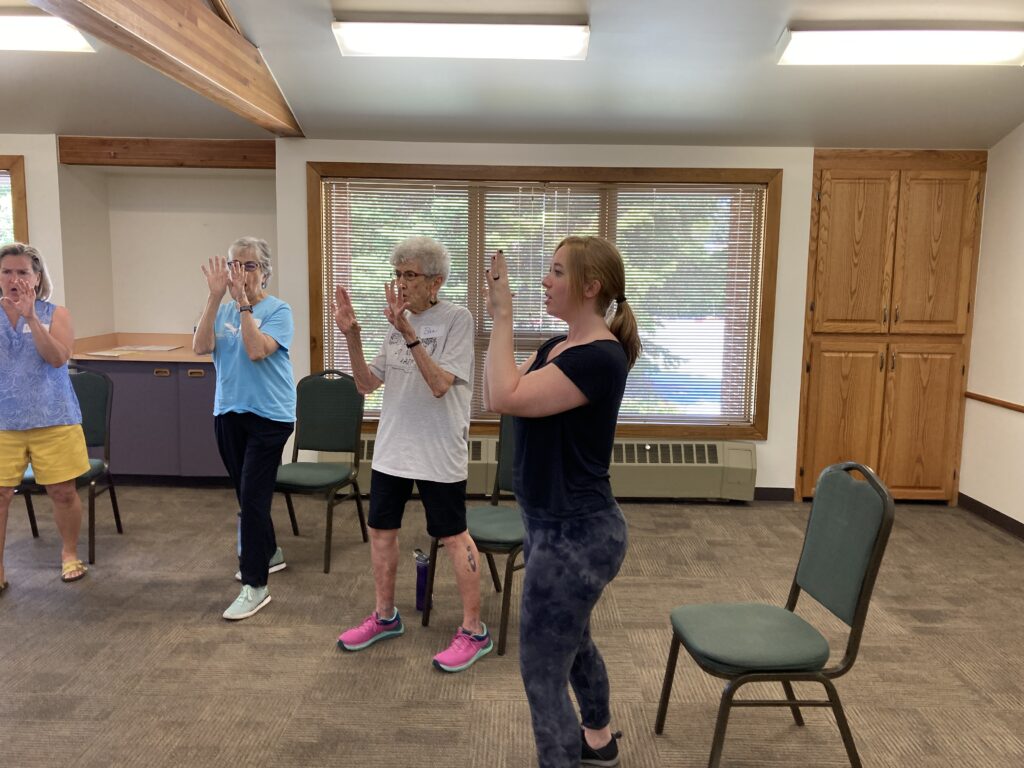 Adaptive Self-defense class with varying ages all in a safety stance.