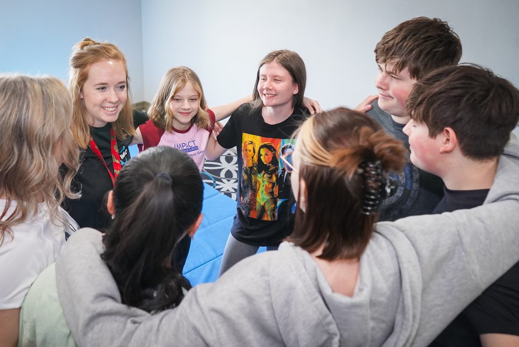 Teens in a huddle in our teen-self-defense class.